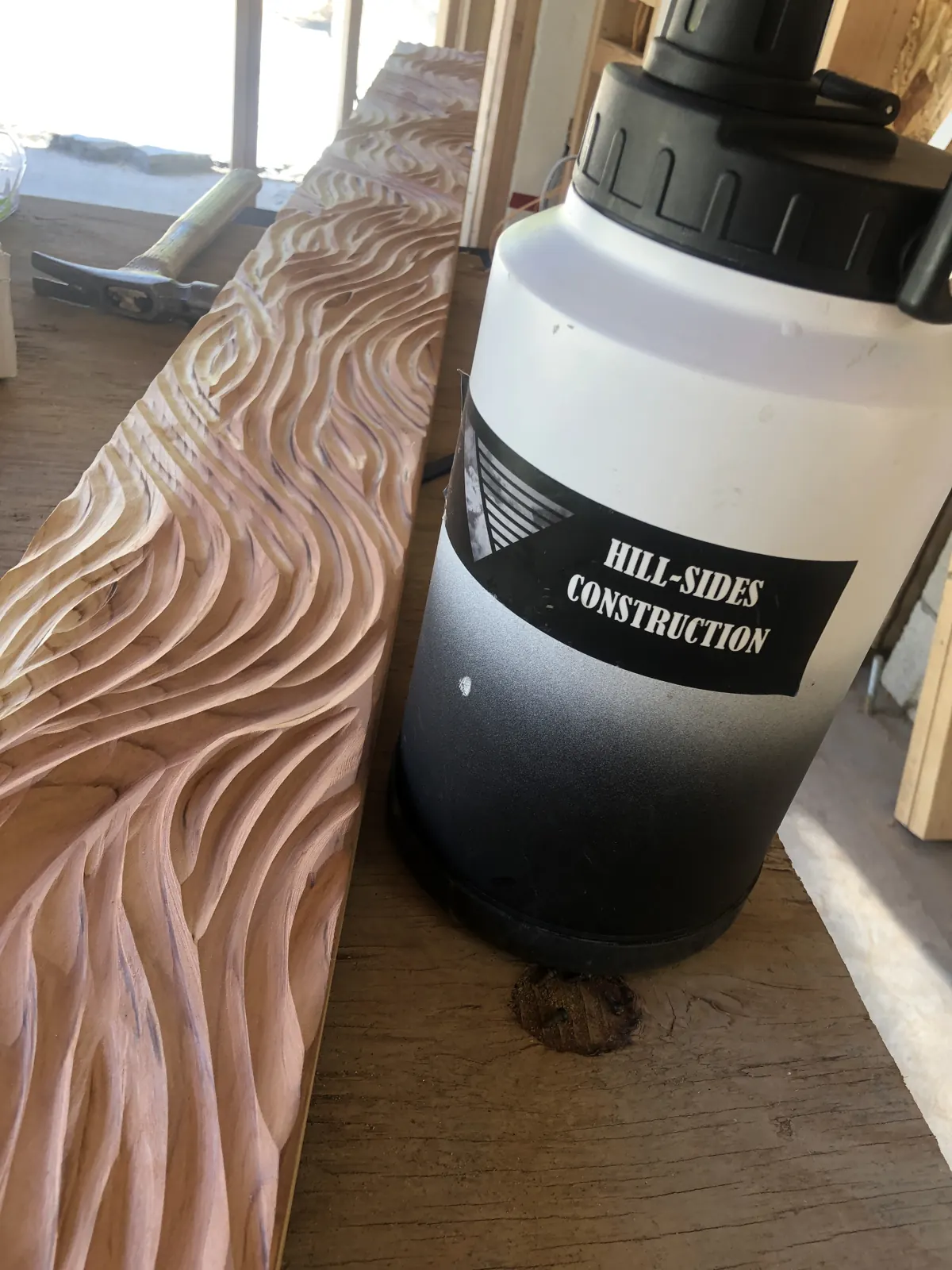 Hand-shaped wave pattern carved into a header board