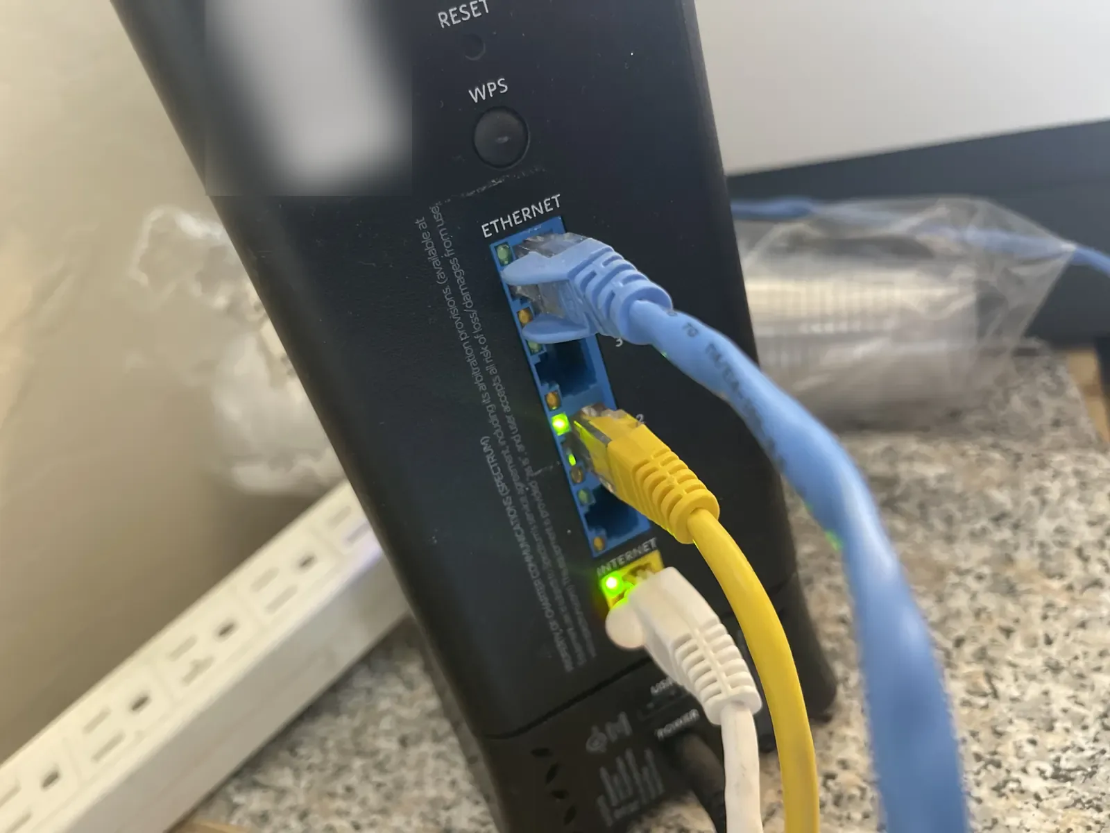 Modem/router with blue and yellow ethernet cables