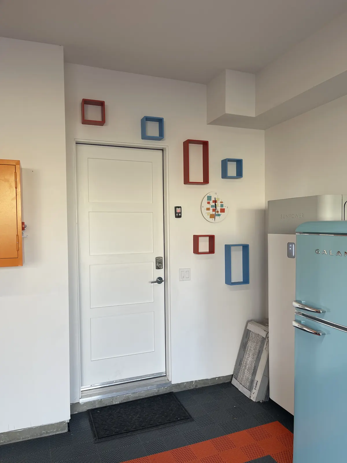 Entry wall with small framed pieces arranged around a door