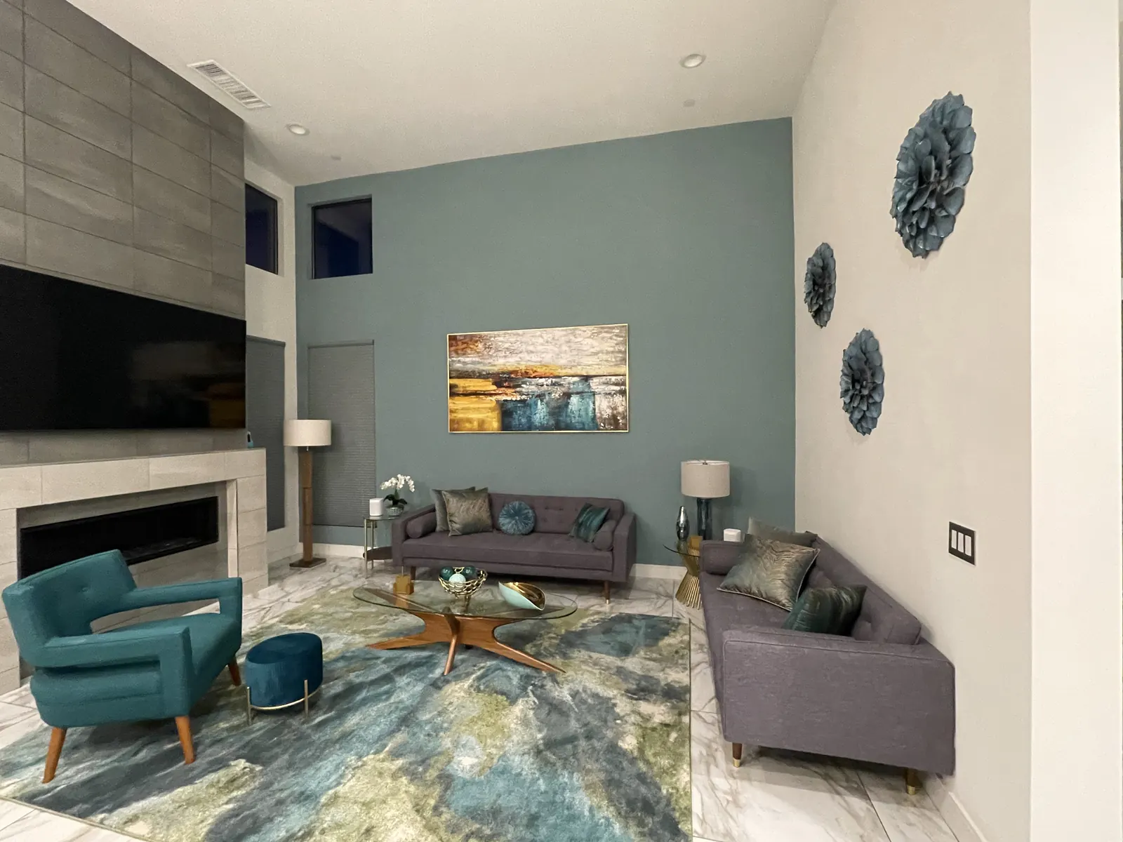 Living room with a large canvas and round wall pieces hung over the seating