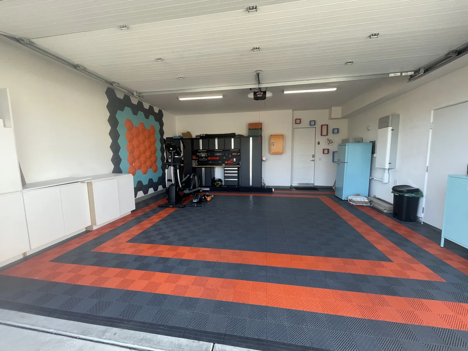 After: finished garage floor with an orange and grey tile border